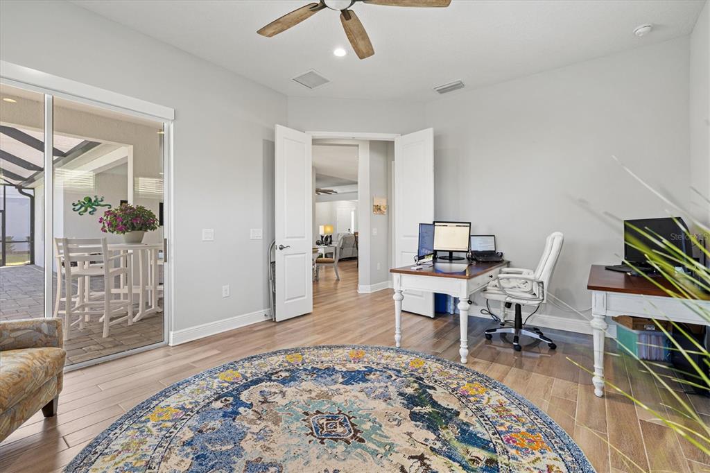 12436 Destin Loop Venice, FL 34293 - Photo 25 of 85 a workspace with wooden floor and a rug