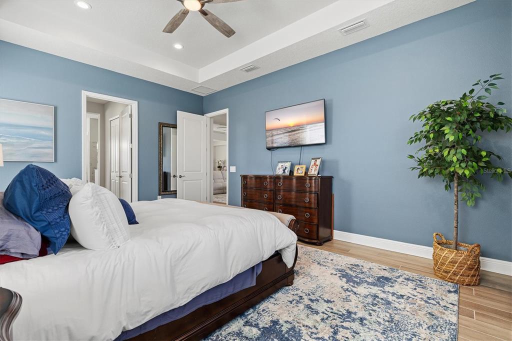 12436 Destin Loop Venice, FL 34293 - Photo 28 of 85 a bedroom with a bed and a potted plant