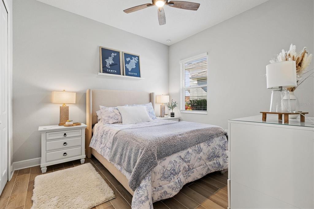 12436 Destin Loop Venice, FL 34293 - Photo 34 of 85 a bedroom with a bed and a chandelier