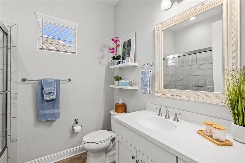 12436 Destin Loop Venice, FL 34293 - Photo 35 of 85 a bathroom with a sink vanity mirror and toilet