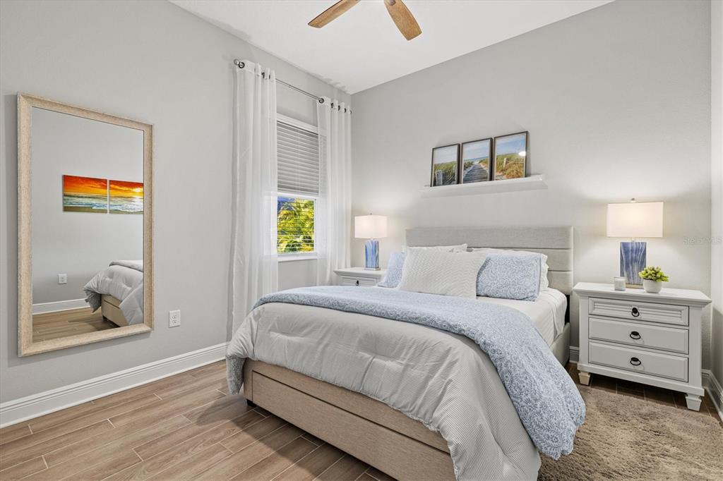 12436 Destin Loop Venice, FL 34293 - Photo 36 of 85 a bedroom with a bed and a painting on the wall