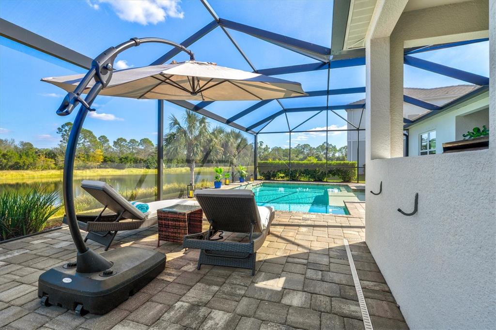 12436 Destin Loop Venice, FL 34293 - Photo 46 of 85 a view of a patio with a table chairs and a umbrella