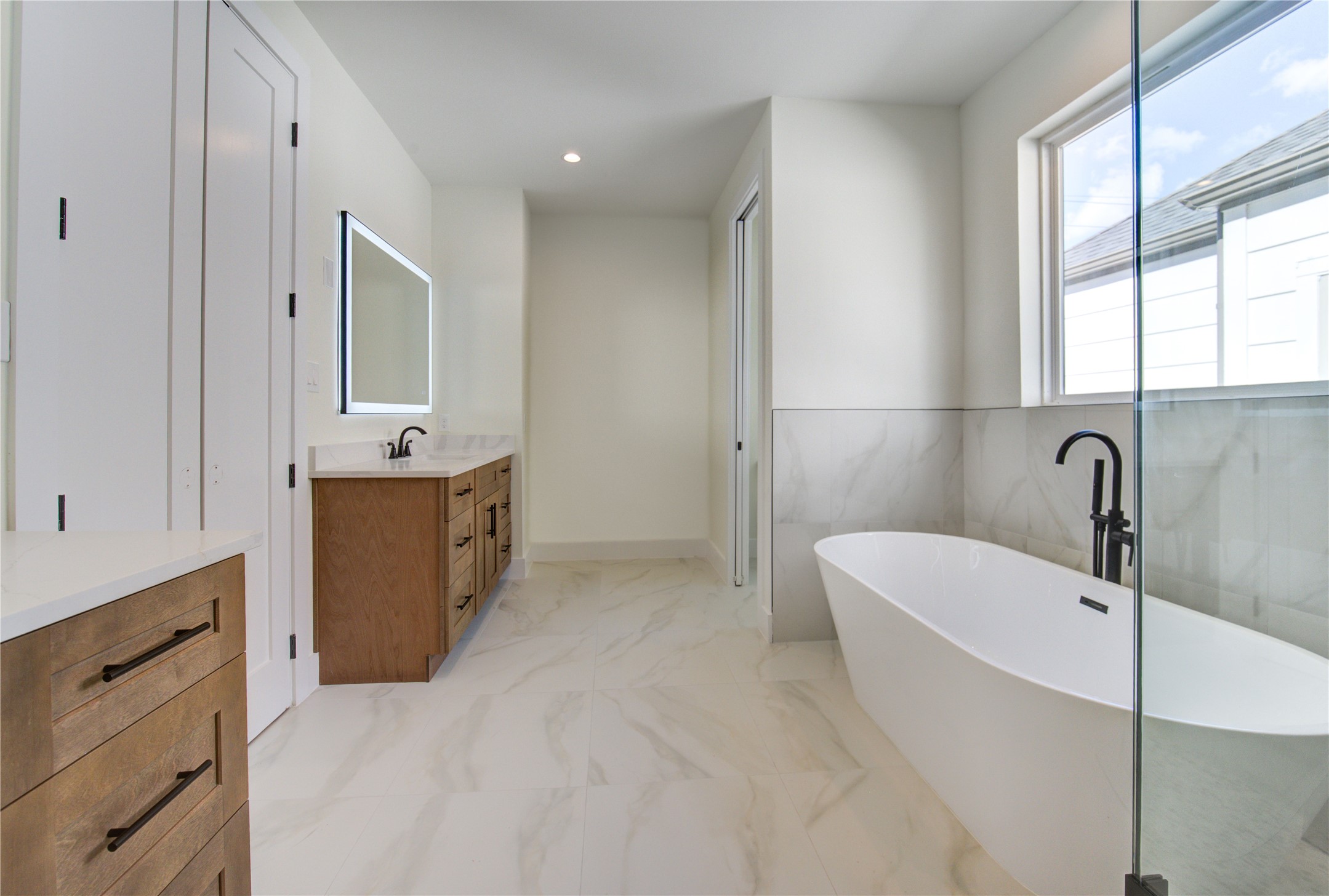 1810 Hazard Street, Unit A Houston, TX 77019 - Photo 11 of 47 a bathroom with a bathtub sink and mirror