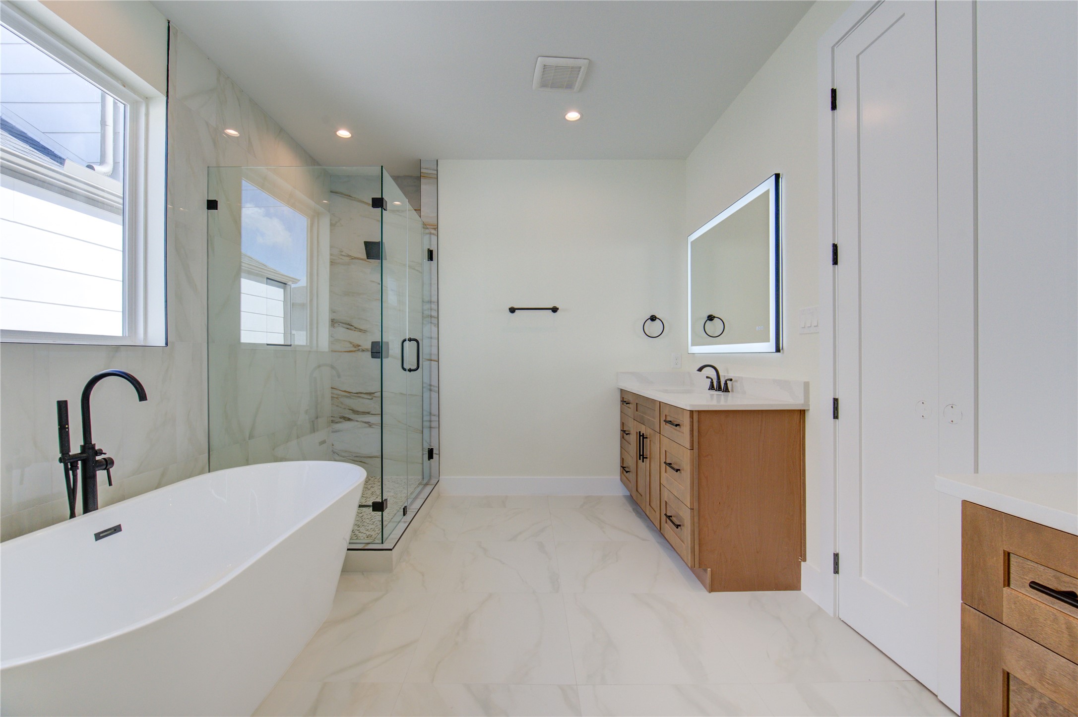 1810 Hazard Street, Unit A Houston, TX 77019 - Photo 17 of 47 a bathroom with a tub sink double vanity granite tub shower and mirror
