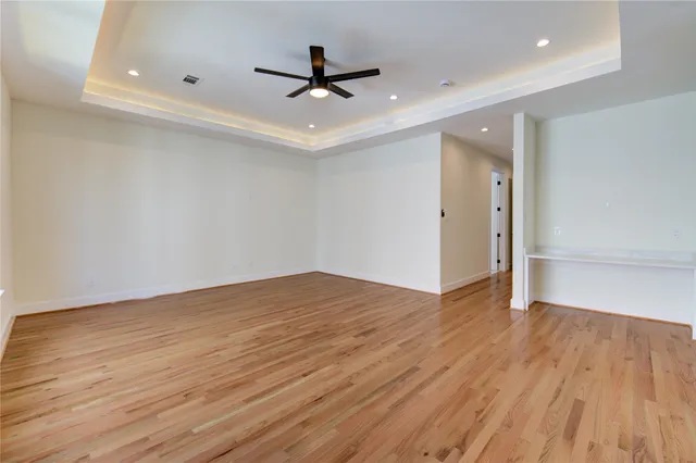 a view of a livingroom with a hardwood floor and a ceiling fan