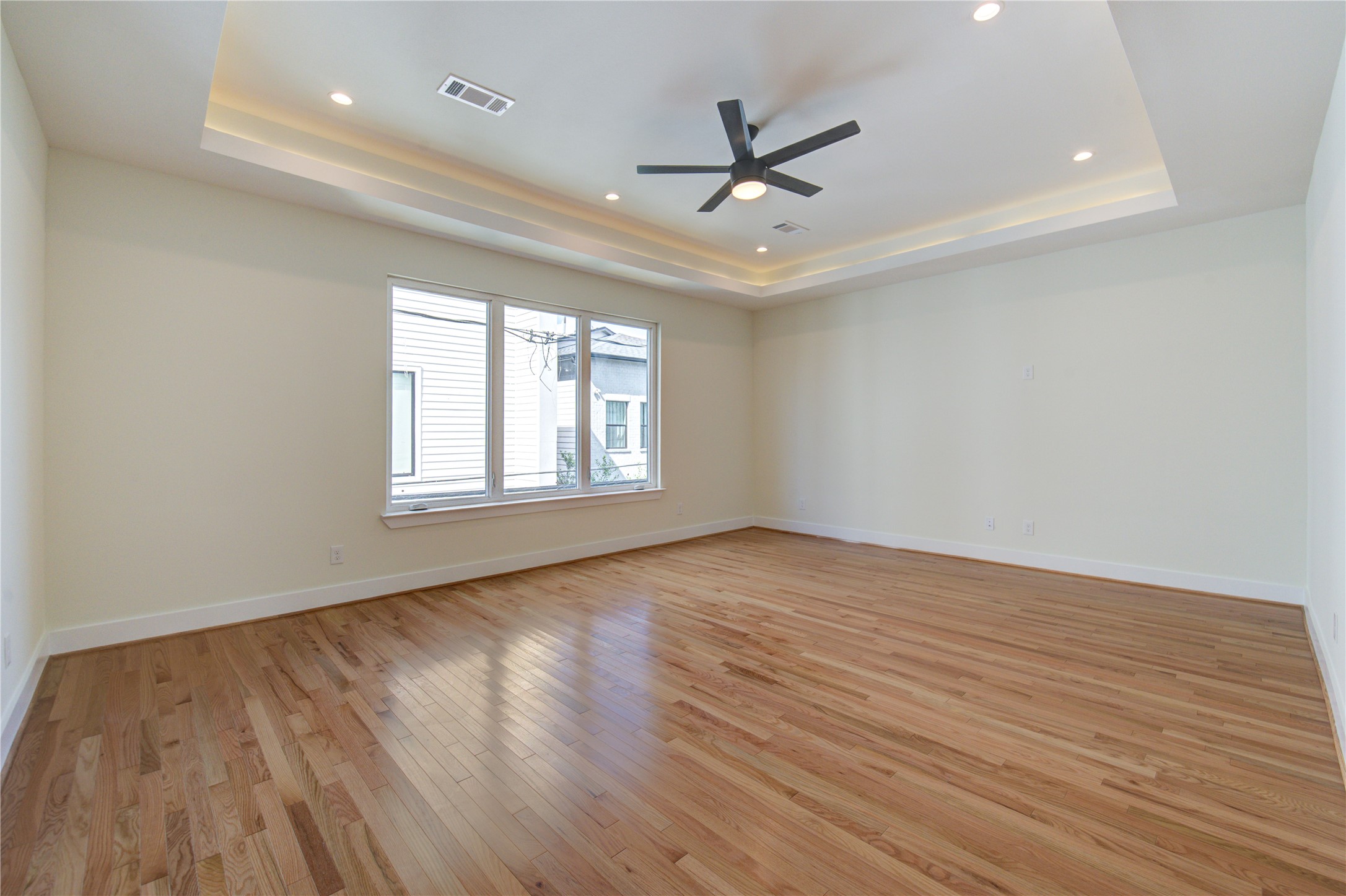 1810 Hazard Street, Unit A Houston, TX 77019 - Photo 23 of 47 an empty room with wooden floor ceiling fan and windows