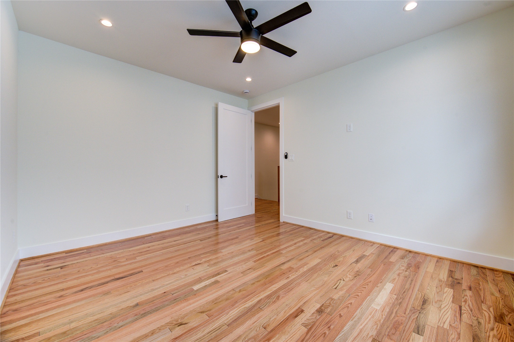 1810 Hazard Street, Unit A Houston, TX 77019 - Photo 26 of 47 an empty room with wooden floor and ceiling fan