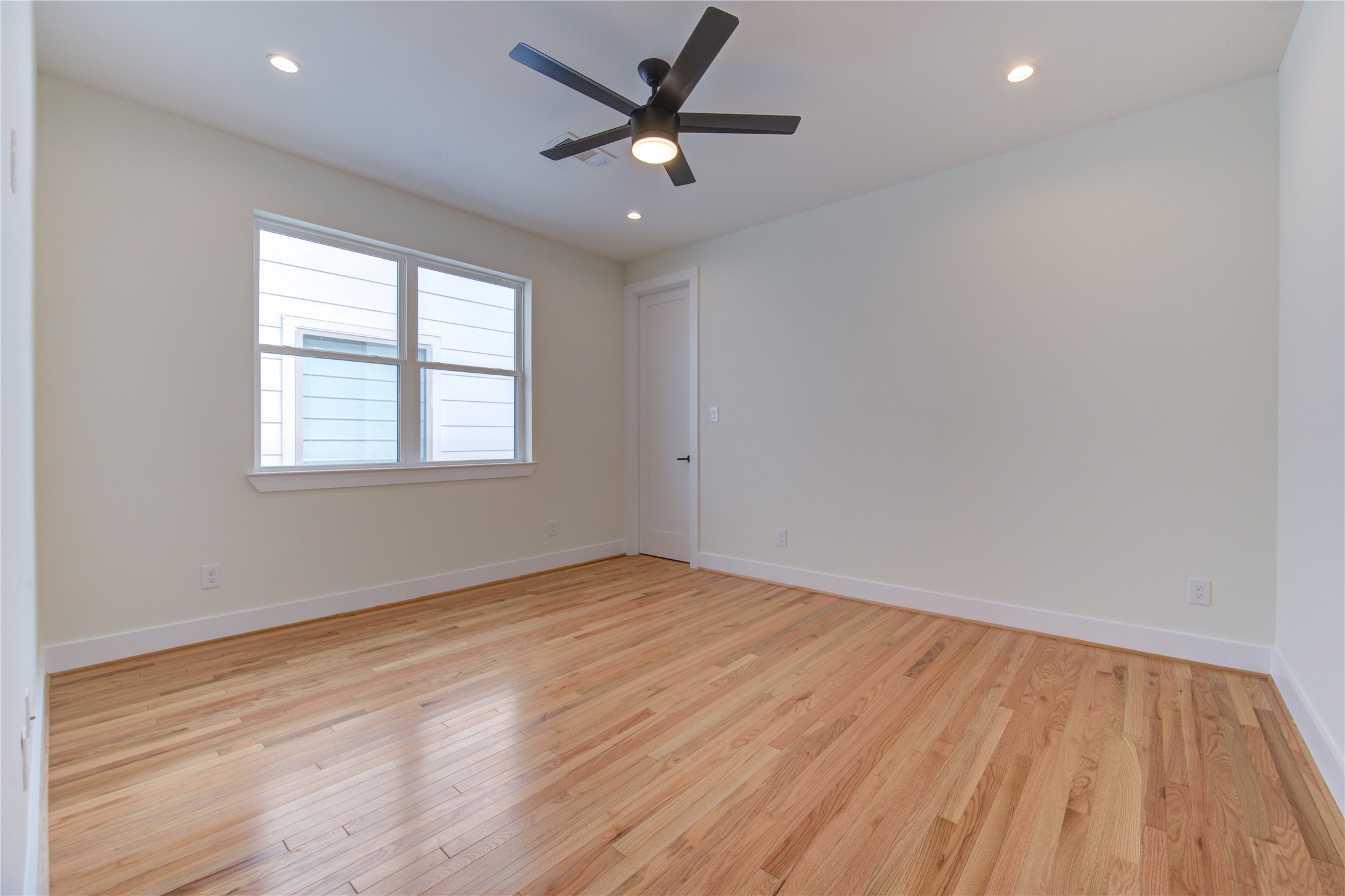 1810 Hazard Street, Unit A Houston, TX 77019 - Photo 27 of 47 an empty room with wooden floor and windows