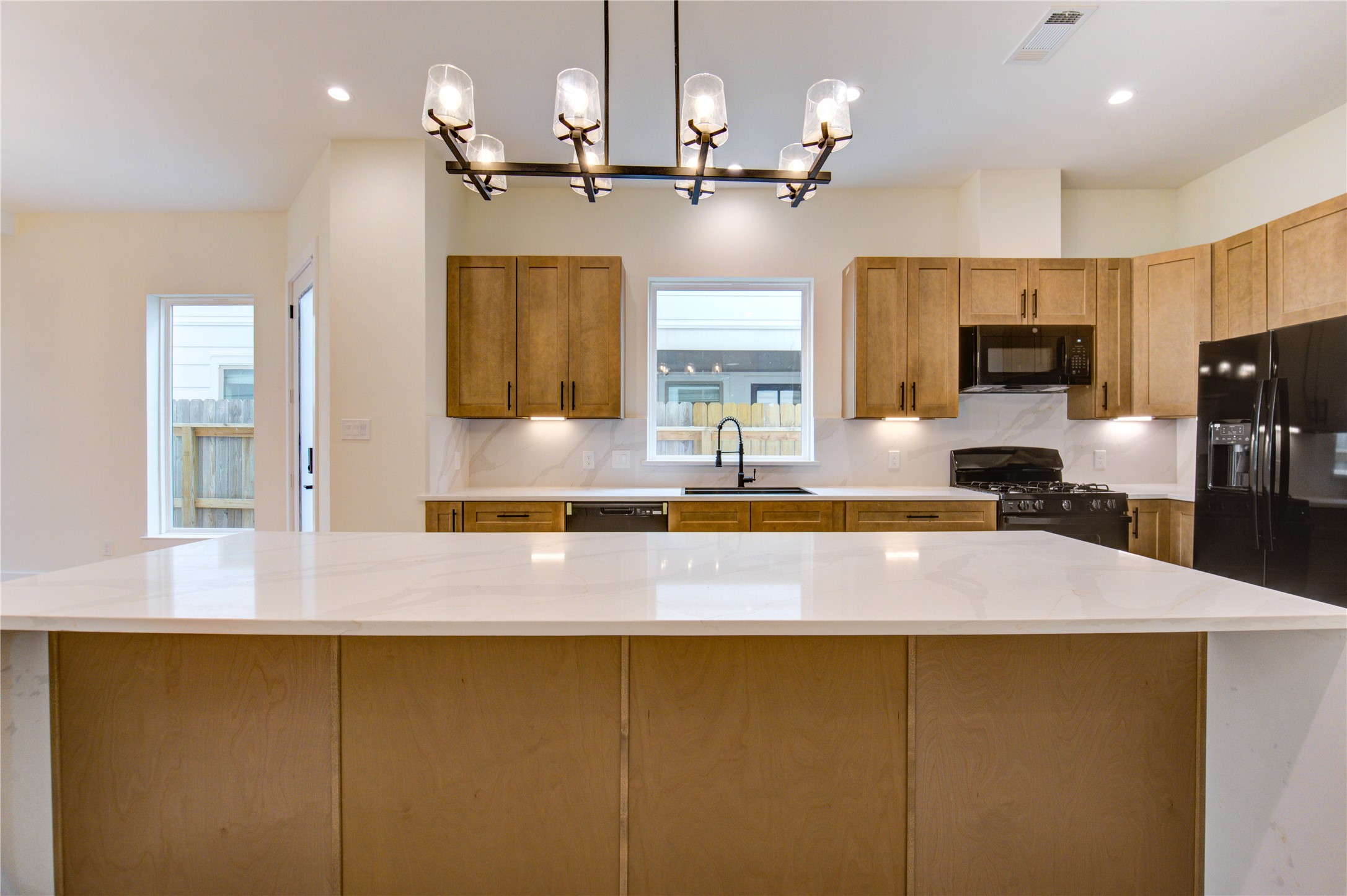 1810 Hazard Street, Unit A Houston, TX 77019 - Photo 32 of 47 a kitchen with kitchen island a sink stainless steel appliances and cabinets