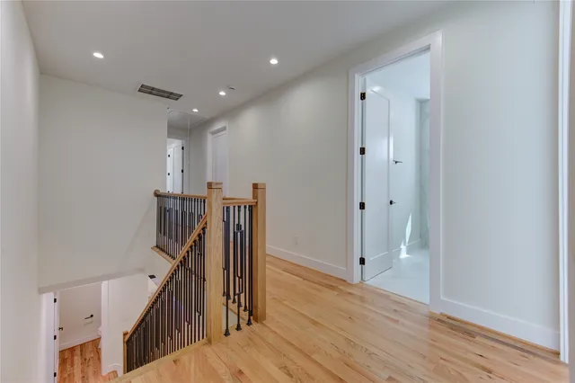 a view of a hallway with wooden floor