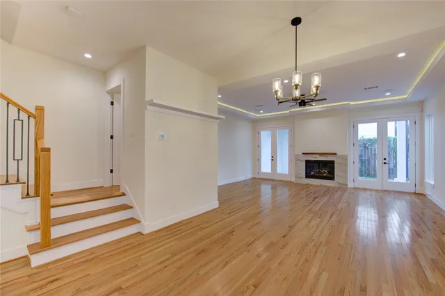 a view of a livingroom with wooden floor and fireplace