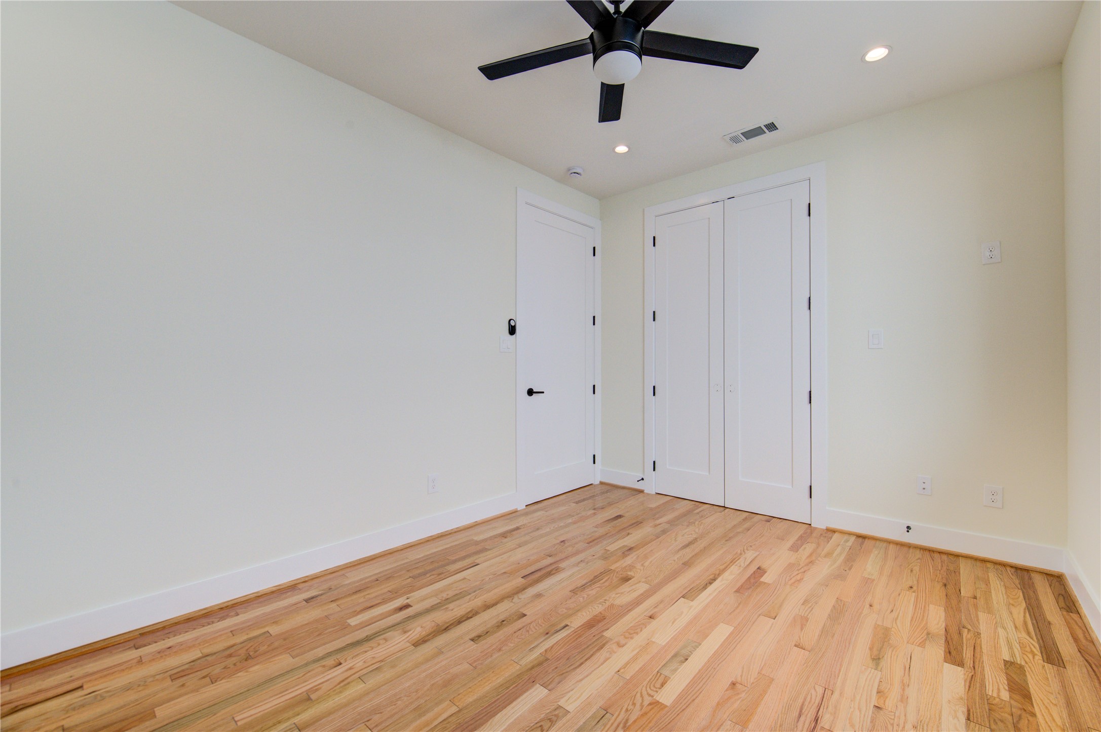 1810 Hazard Street, Unit A Houston, TX 77019 - Photo 8 of 47 an empty room with a ceiling fan and wooden floor