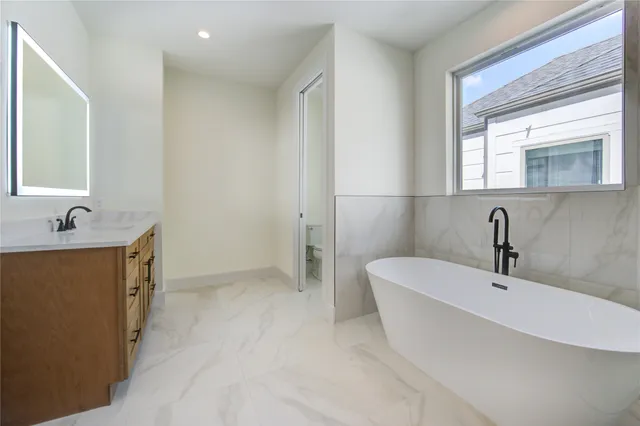 a bathroom with a bathtub and a sink