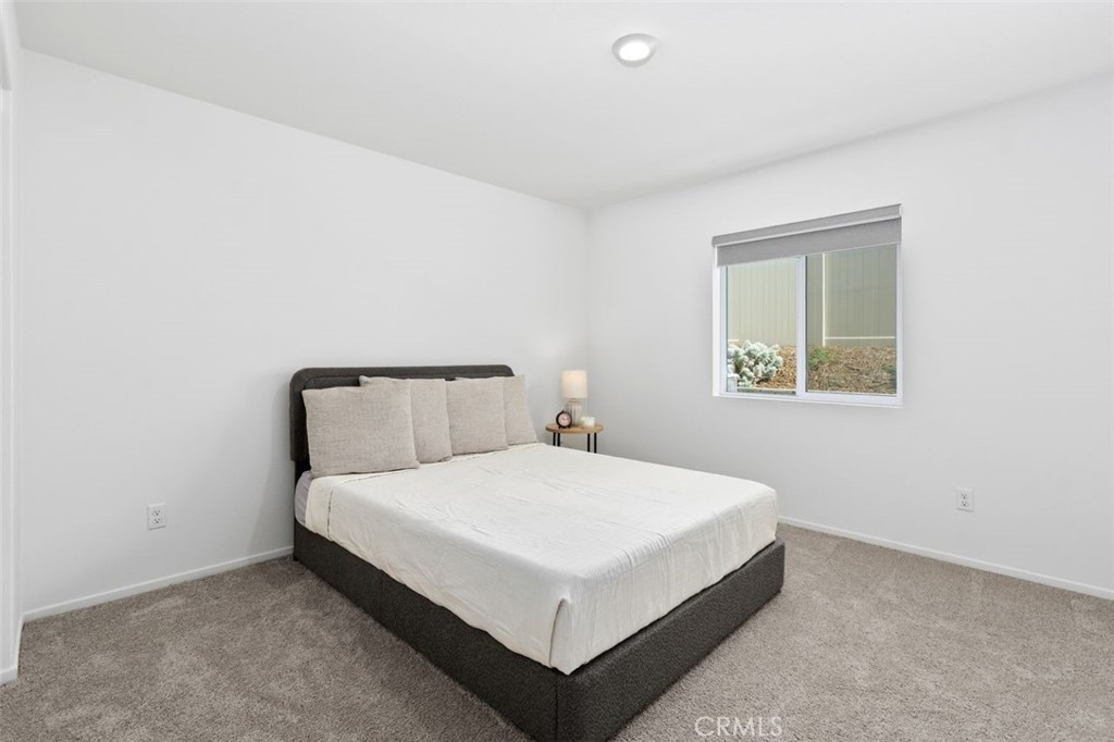 28876 Camaro Drive Winchester, CA 92596 - Photo 21 of 44 a large bed sitting in a bedroom next to a window