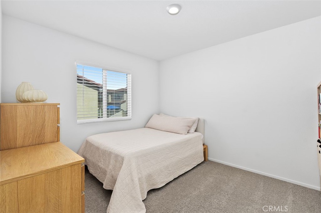 28876 Camaro Drive Winchester, CA 92596 - Photo 27 of 44 a bedroom with a bed and window