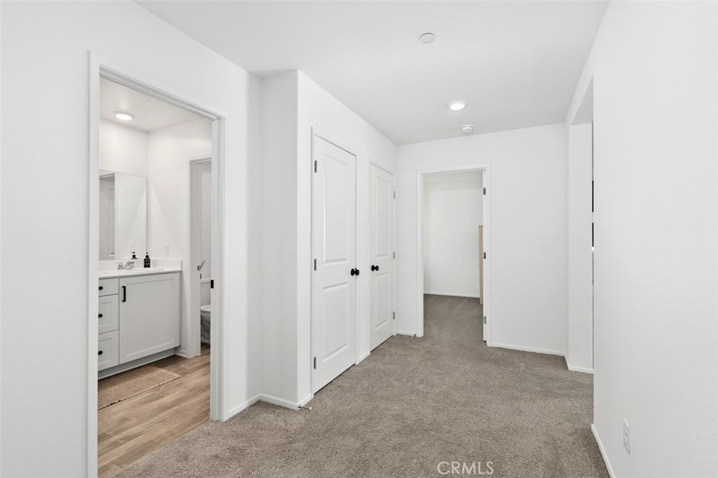 28876 Camaro Drive Winchester, CA 92596 - Photo 28 of 44 a view of a hallway with closet and wooden floor