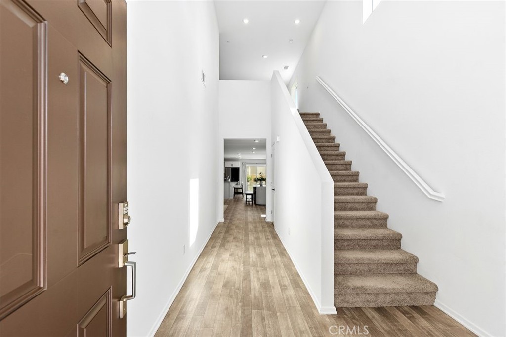 28876 Camaro Drive Winchester, CA 92596 - Photo 4 of 44 a view of a hallway with stairs and wooden floor