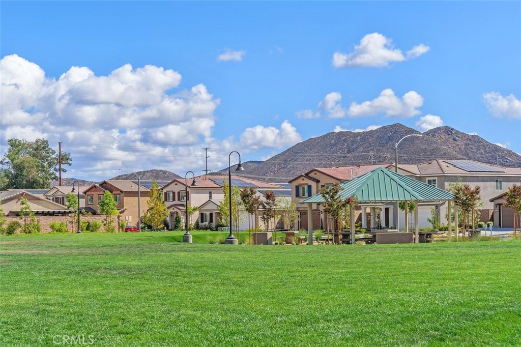 28876 Camaro Drive Winchester, CA 92596 - Photo 41 of 44 a view of a big yard with table and chairs under an umbrella