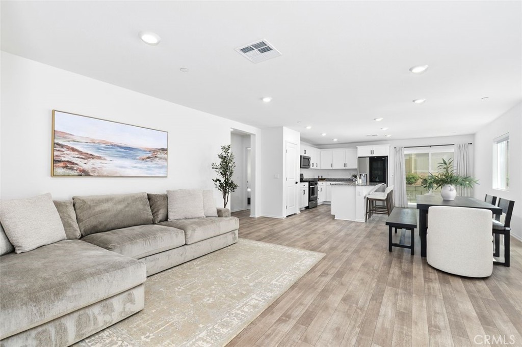28876 Camaro Drive Winchester, CA 92596 - Photo 5 of 44 a living room with furniture and a dining table with kitchen view