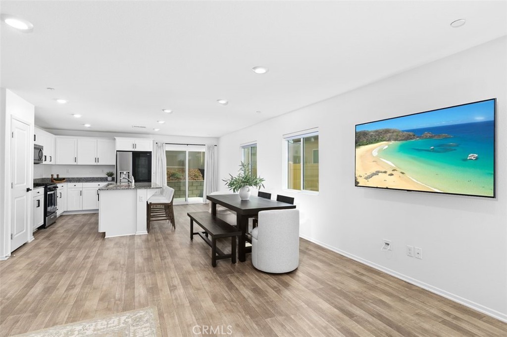 28876 Camaro Drive Winchester, CA 92596 - Photo 8 of 44 a living room with furniture a flat screen tv and kitchen view