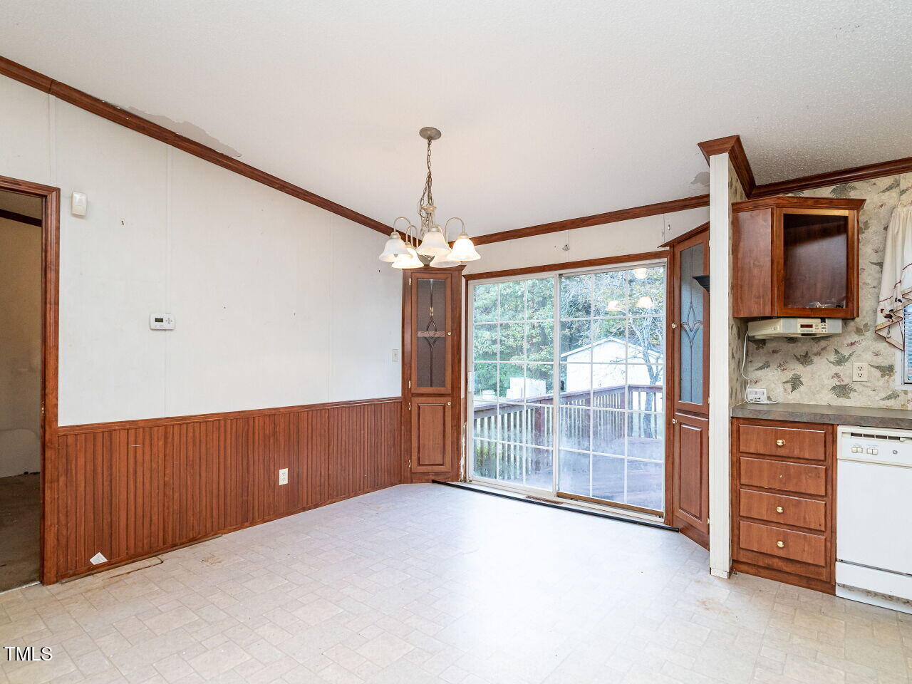 9140 Ransdell Road Raleigh, NC 27603 - Photo 13 of 26 a view of an empty room with a cabinet and a large window