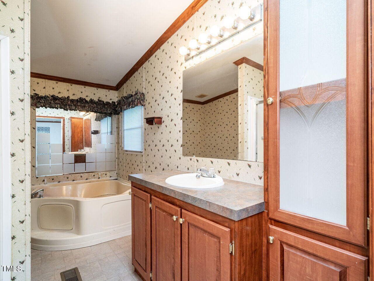 9140 Ransdell Road Raleigh, NC 27603 - Photo 17 of 26 a bathroom with a sink and a mirror