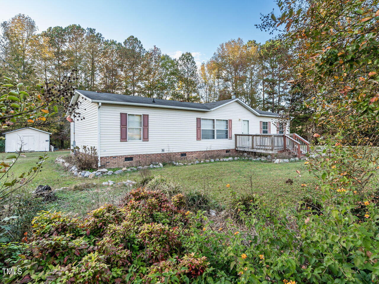 9140 Ransdell Road Raleigh, NC 27603 - Photo 2 of 26 a view of a house with a big yard and large trees