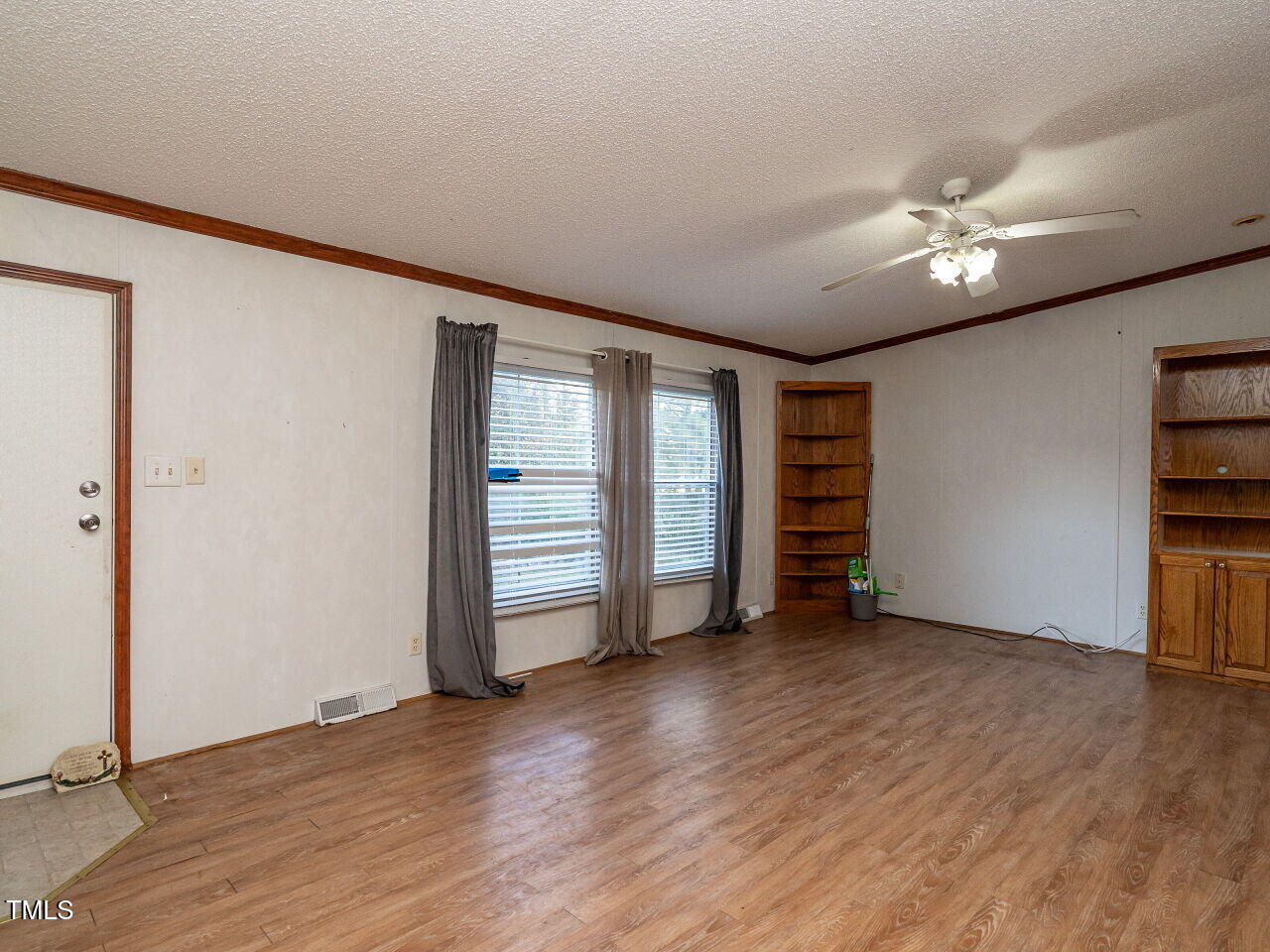 9140 Ransdell Road Raleigh, NC 27603 - Photo 6 of 26 an empty room with wooden floor closet and windows