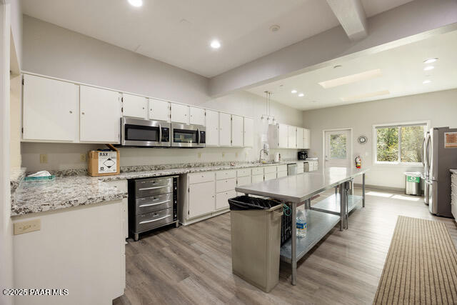 4600 Prairie Trail Prescott, AZ 86301 - Photo 17 of 19 a kitchen with stainless steel appliances granite countertop wooden cabinets a sink dishwasher a stove and a refrigerator