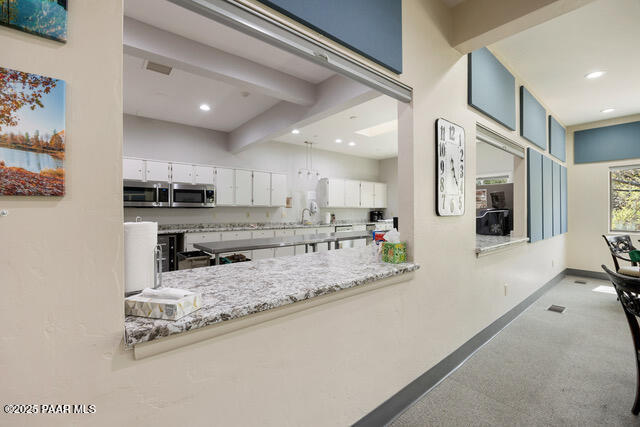 4600 Prairie Trail Prescott, AZ 86301 - Photo 18 of 19 a large kitchen with stainless steel appliances granite countertop a large counter top and a stove