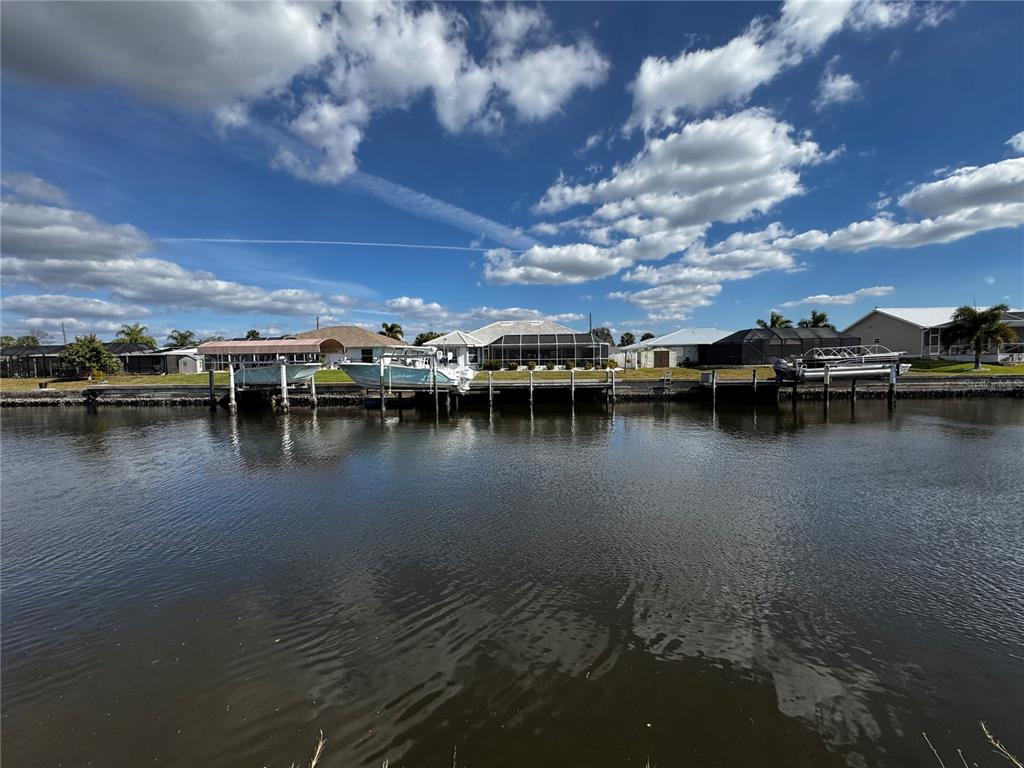 4366 Wynkoop Circle Port Charlotte, FL 33948 - Photo 5 of 8 a view of a lake with boats and trees