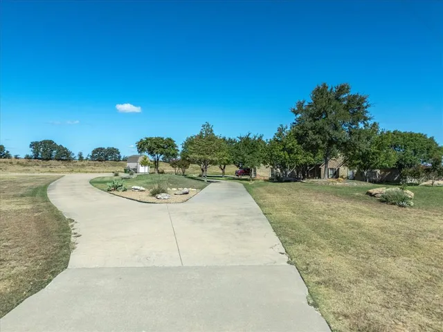 a view of a swimming pool with a yard