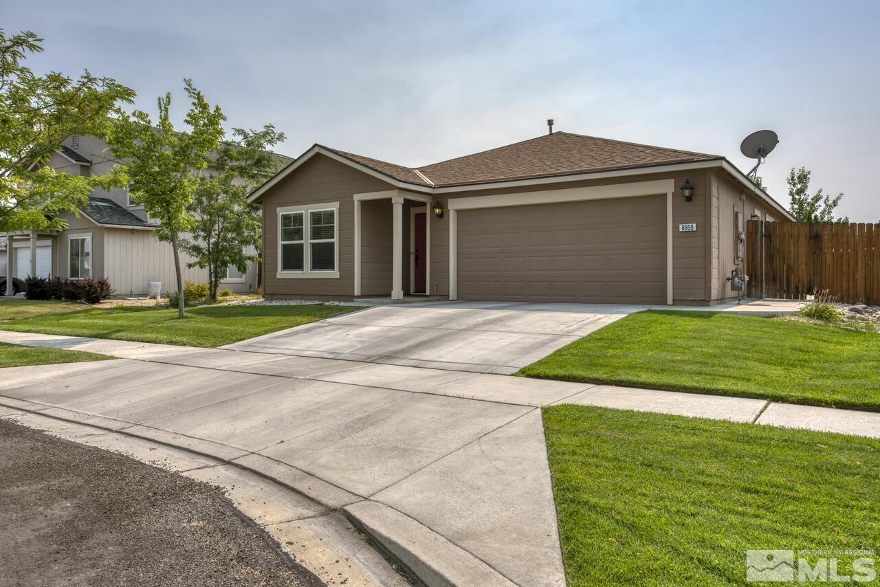 8950 Yeager Street Reno, NV 89506 - Photo 1 of 40 a front view of a house with a yard and garage
