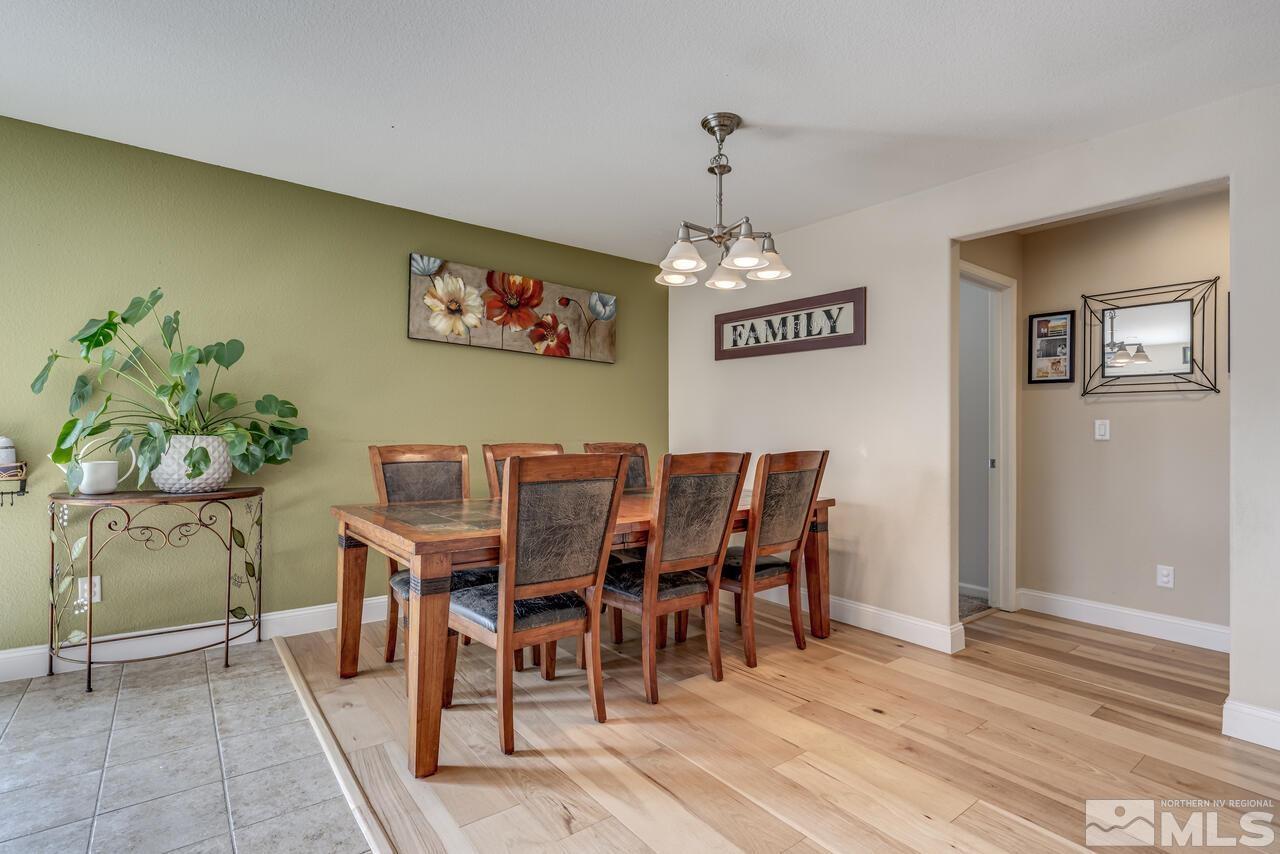 8950 Yeager Street Reno, NV 89506 - Photo 17 of 40 a view of a dining room with furniture and wooden floor