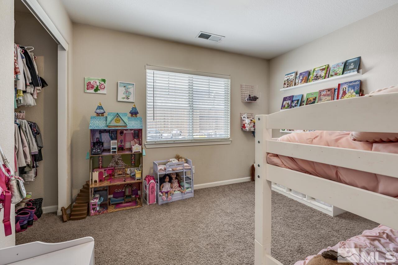 8950 Yeager Street Reno, NV 89506 - Photo 28 of 40 a bedroom with a bed and a window