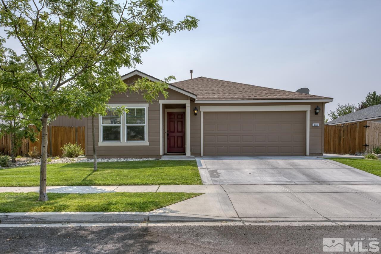 8950 Yeager Street Reno, NV 89506 - Photo 3 of 40 a front view of a house with a yard and garage