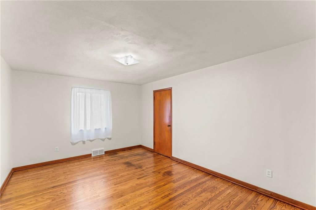 107 Robinson Church Road Bulger, PA 15019 - Photo 14 of 30 an empty room with wooden floor and windows