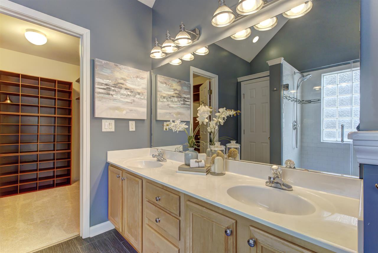 Dual vanity has tons of counter and cabinet space for everyone! Owners Bath