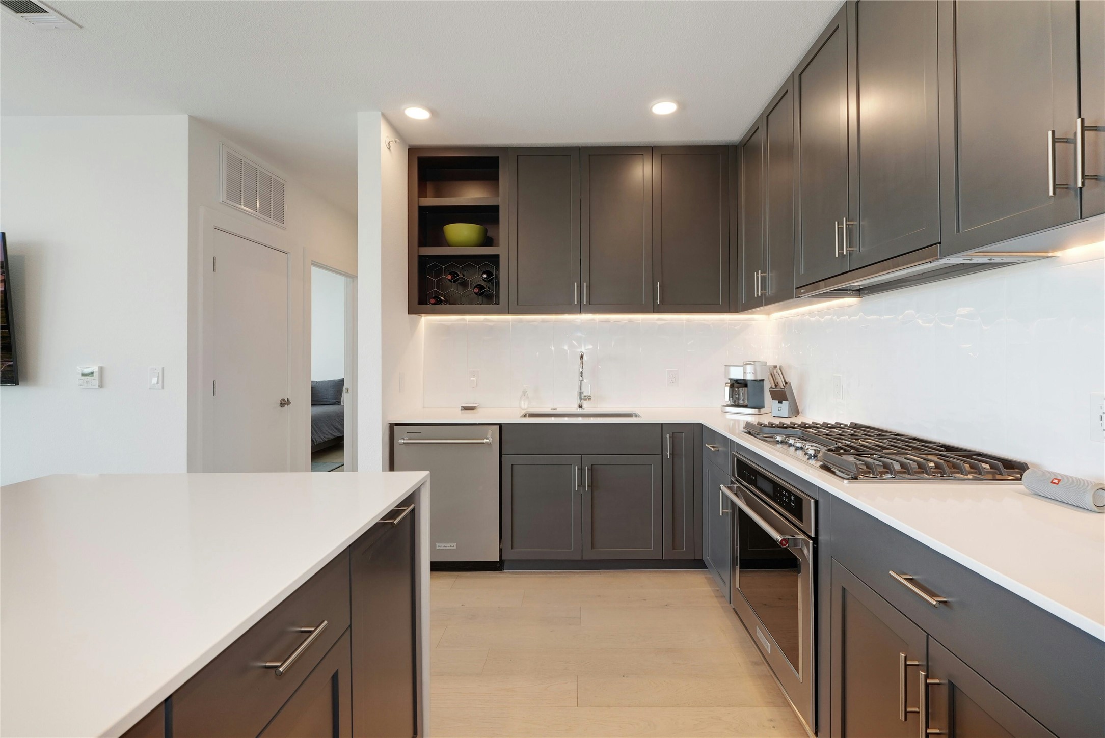 1600 South 1st Street, Unit 403 Austin, TX 78704 - Photo 11 of 33 a kitchen with granite countertop stainless steel appliances a sink stove and cabinets