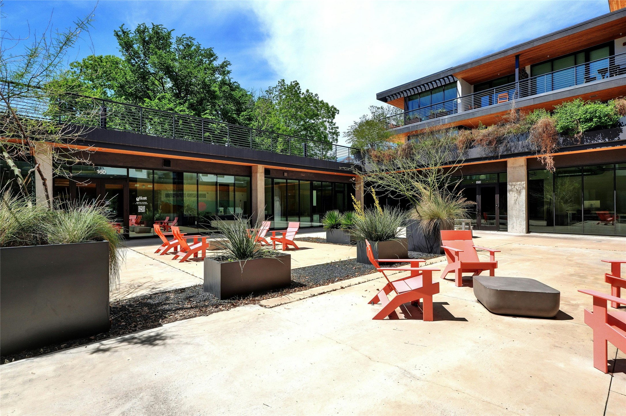 1600 South 1st Street, Unit 403 Austin, TX 78704 - Photo 28 of 33 a view of a patio with couches table and chairs potted plants and large tree