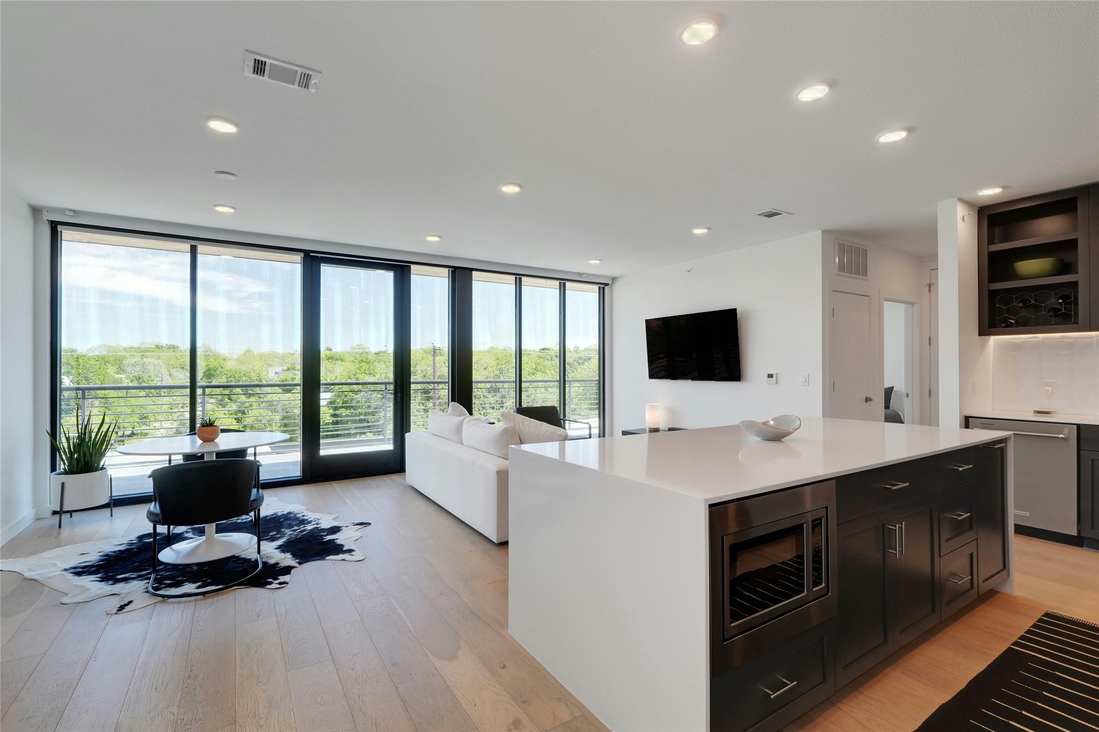 1600 South 1st Street, Unit 403 Austin, TX 78704 - Photo 4 of 33 a living room with furniture a flat screen tv and a floor to ceiling window