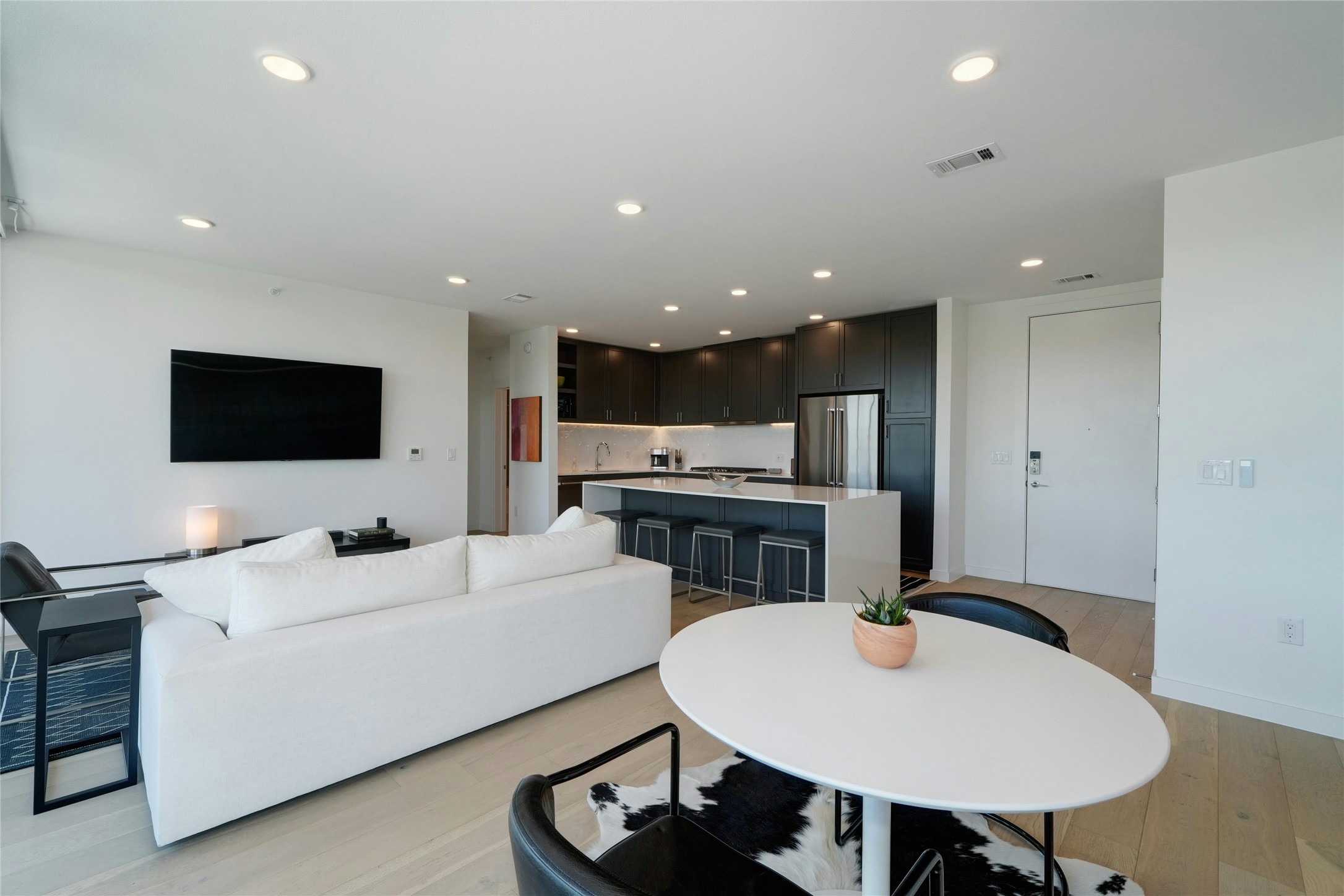 1600 South 1st Street, Unit 403 Austin, TX 78704 - Photo 7 of 33 a living room with stainless steel appliances kitchen island furniture a flat screen tv and kitchen view