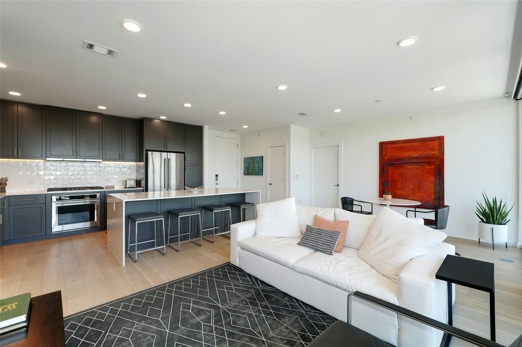 1600 South 1st Street, Unit 403 Austin, TX 78704 - Photo 8 of 33 a living room with stainless steel appliances furniture a fireplace and a open kitchen view