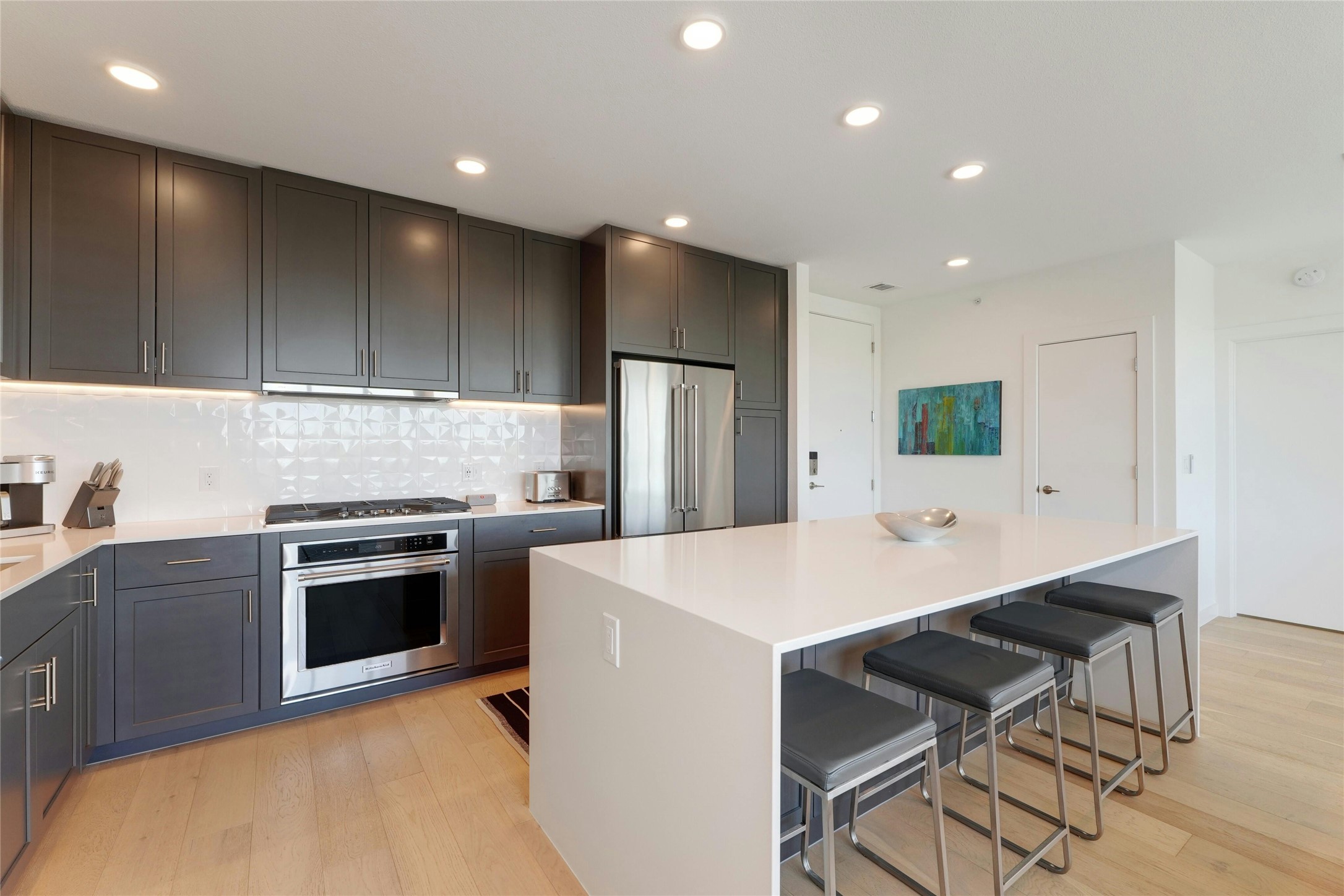 1600 South 1st Street, Unit 403 Austin, TX 78704 - Photo 9 of 33 a kitchen with kitchen island a stove a sink a refrigerator and cabinets
