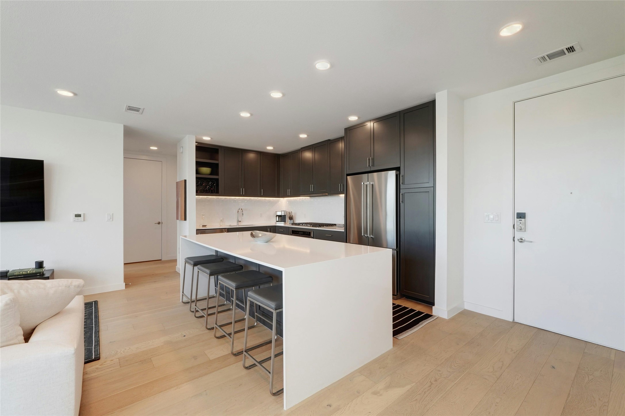 1600 South 1st Street, Unit 403 Austin, TX 78704 - Photo 10 of 33 a large kitchen with kitchen island a sink stainless steel appliances and cabinets