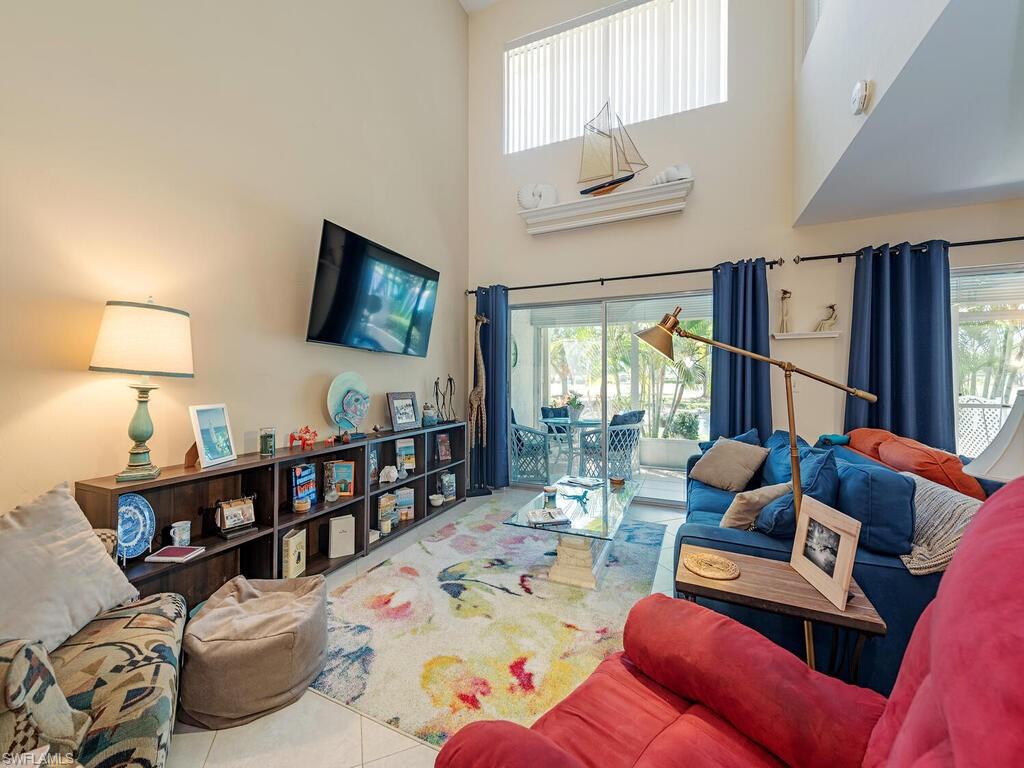 508 Bristle Cone Lane, Unit 55 Naples, FL 34113 - Photo 3 of 19 a living room with furniture and a flat screen tv