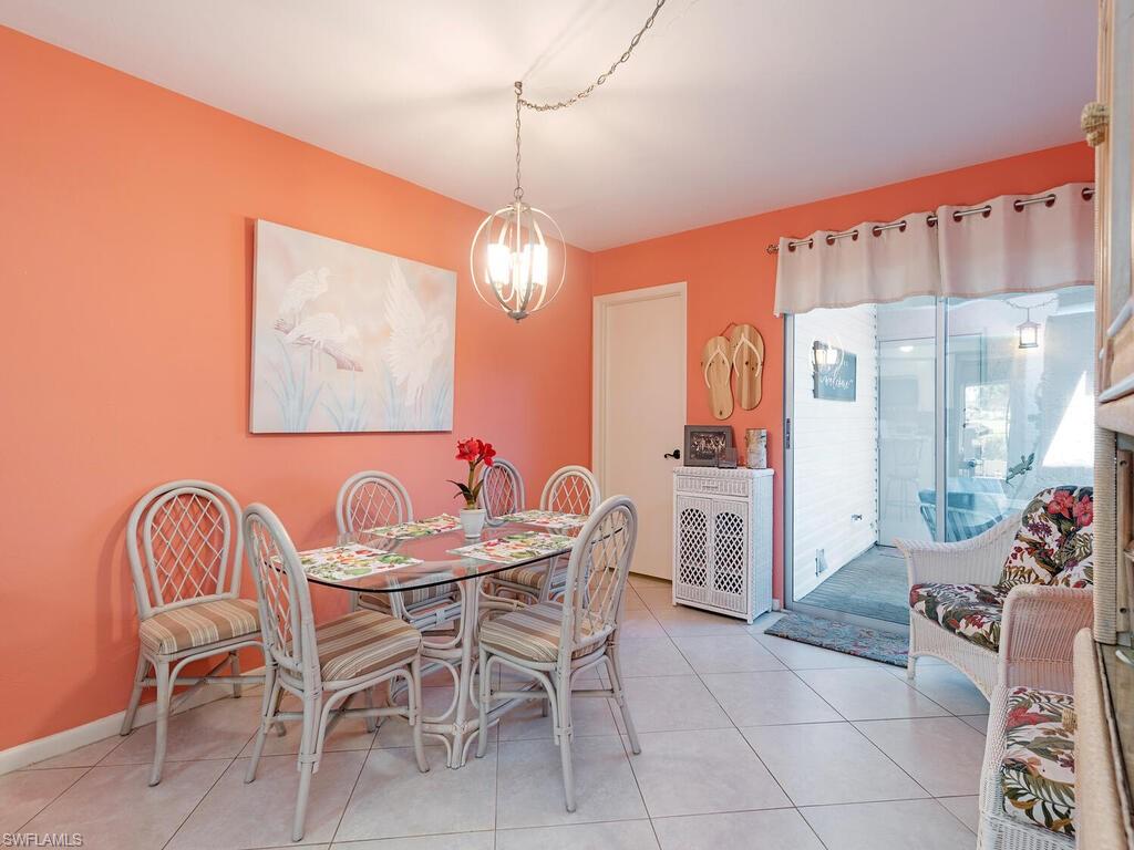 508 Bristle Cone Lane, Unit 55 Naples, FL 34113 - Photo 4 of 19 a view of a dining room with furniture and chandelier
