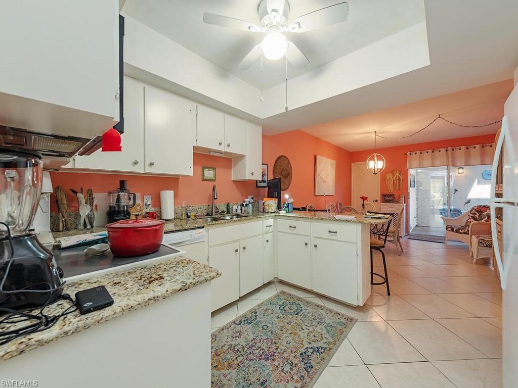 508 Bristle Cone Lane, Unit 55 Naples, FL 34113 - Photo 6 of 19 a kitchen with a sink stove and cabinets