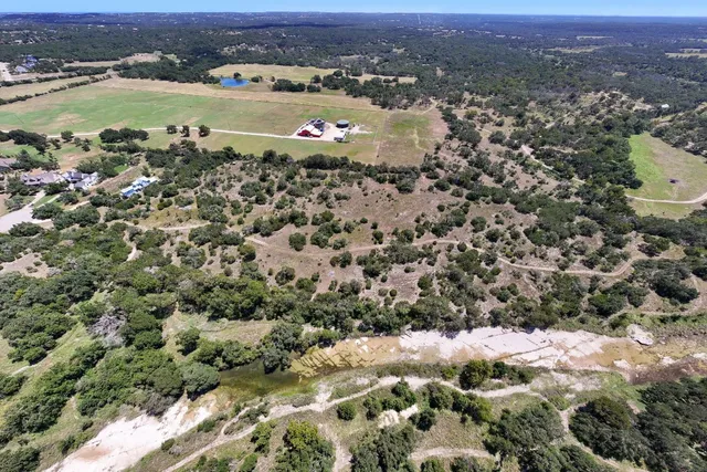 an aerial view of a houses with a lake view