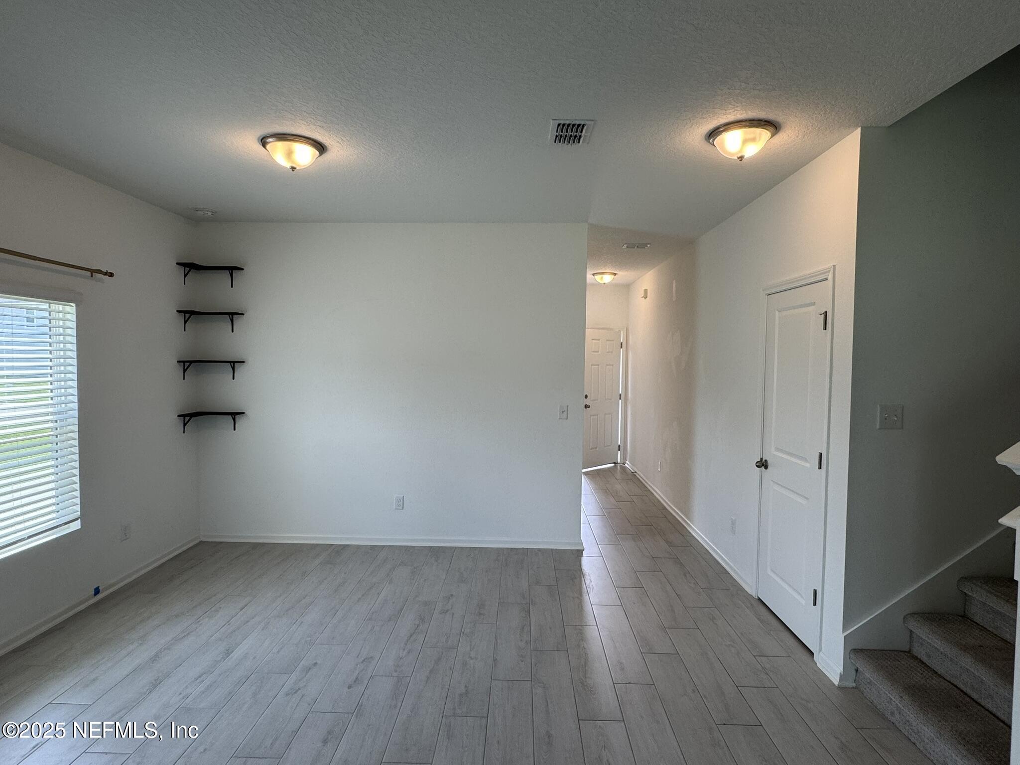 3145 Flower Branch Avenue Orange Park, FL 32073 - Photo 14 of 52 an empty room with wooden floor and windows